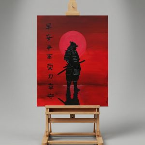 Tableau représentant un samouraï en silhouette noire devant un grand soleil rouge, avec des caractères japonais peints sur la gauche, posé sur un chevalet en bois. Œuvre aux tons rouges intenses réalisée par Art by Alexandra, inspirée de l’esthétique japonaise.